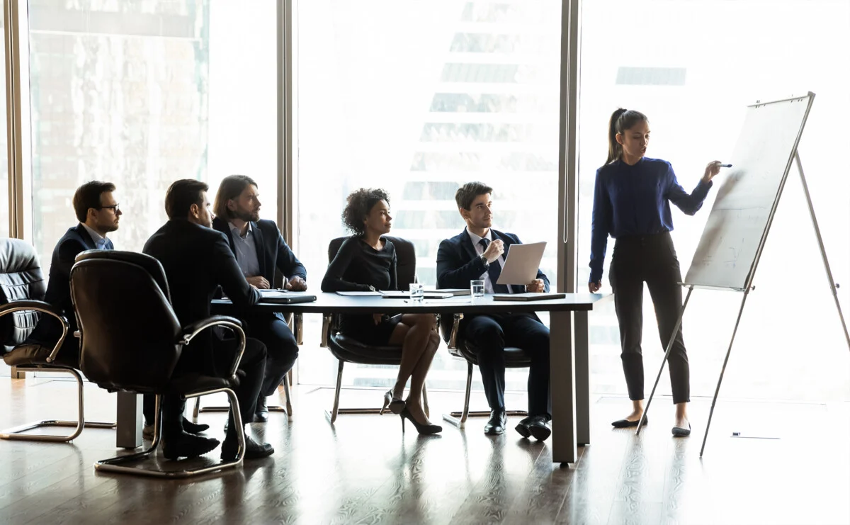 presentazione su lavagna cartacean con persone che seguono attentamente